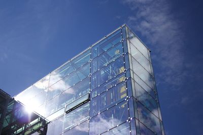 Low angle view of modern building against blue sky