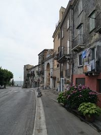 Street amidst buildings against sky