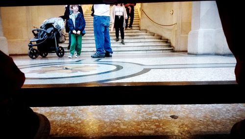 Low section of people walking on staircase