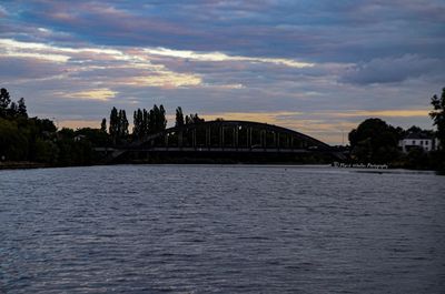 Bridge over river against sky during sunset