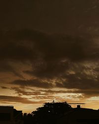 Low angle view of silhouette buildings against sky during sunset