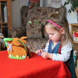 Cute girl holding toy at home