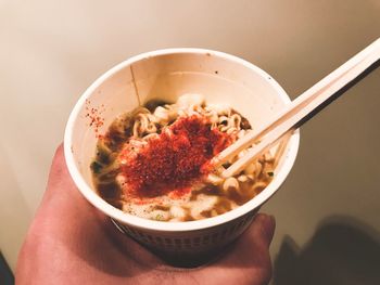 Close-up of person holding food in bowl