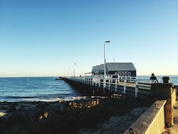 Pier over sea against clear sky