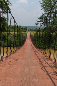 Steel bridge suspended by slings for crossing the river.bridge made of iron and iron sling.