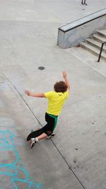 High angle view of falling while skateboarding at park