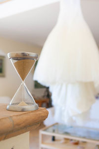 Close-up of hourglass on table at home