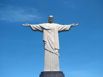 Low angle view of statue against blue sky