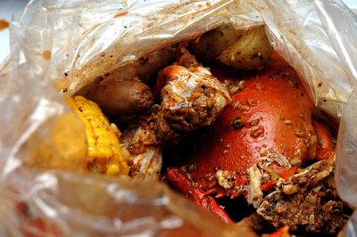 High angle view of crabs and lemon slices in plastic bag