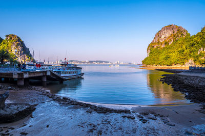 Scenic view of bay against clear blue sky