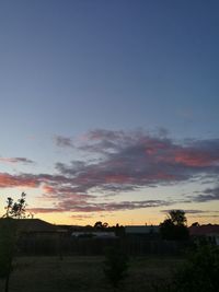 Scenic view of silhouette field against sky during sunset