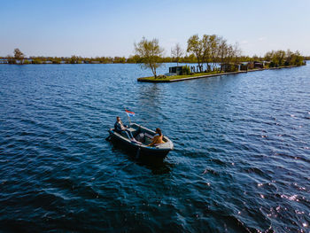 Boat sailing in sea against sky