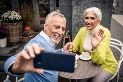 Portrait of a smiling young woman using mobile phone