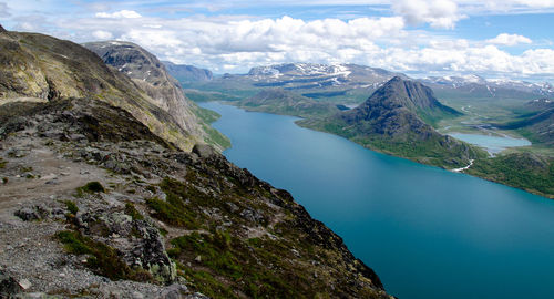 Scenic view of lake and mountains against sky