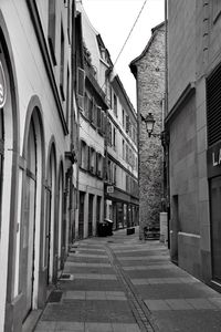 Empty alley amidst buildings in city