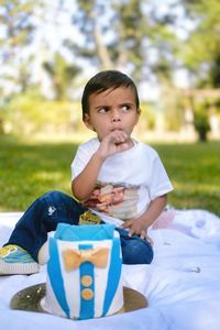 Portrait of cute girl sitting on field