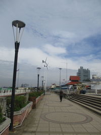 Street lights against sky in city