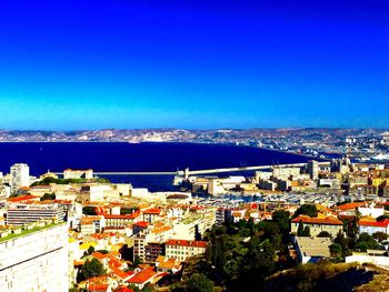 High angle view of cityscape against blue sky