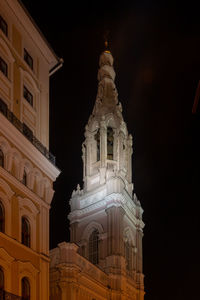 Low angle view of illuminated building against sky at night