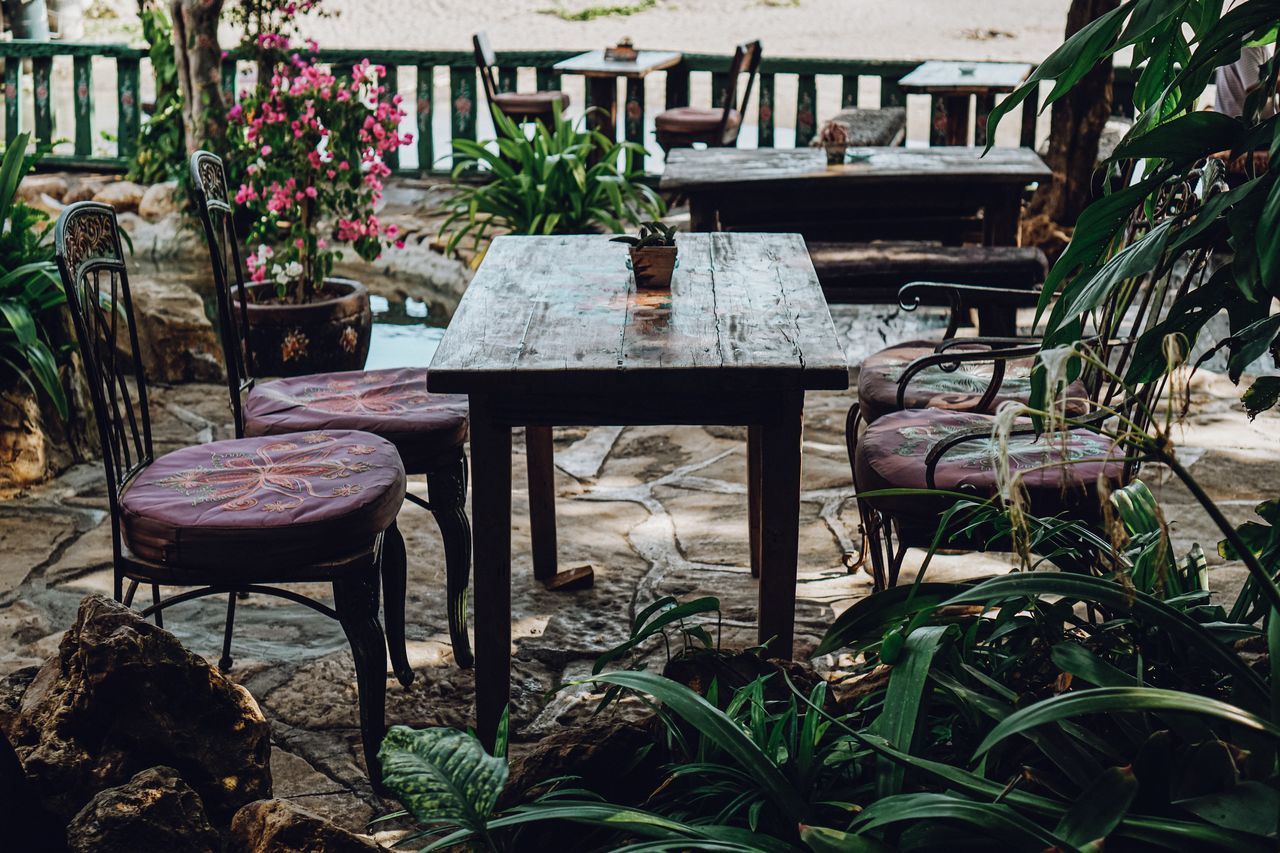 EMPTY CHAIRS AND TABLE AT YARD