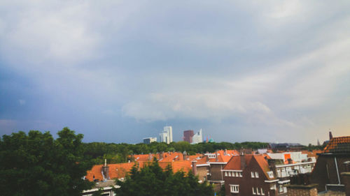 Buildings against cloudy sky