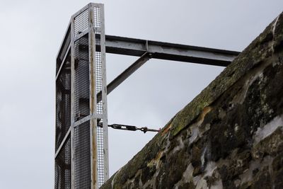 Low angle view of bridge against buildings