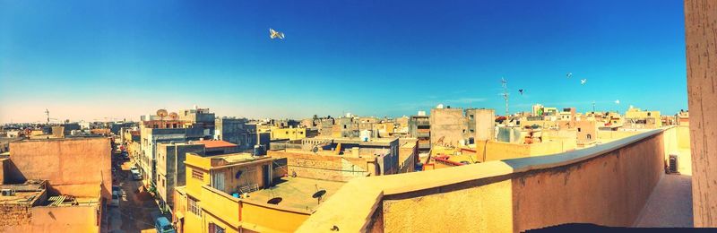 Cityscape against clear blue sky
