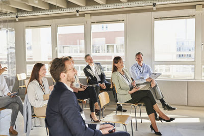 People sitting in front of office building