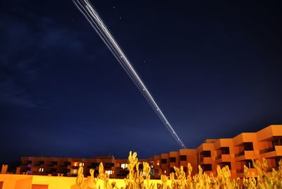 Aerial view of illuminated city against clear sky at night