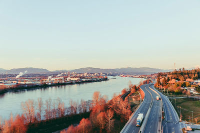 High angle view of river by town against clear sky