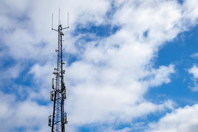 Low angle view of communications tower against sky