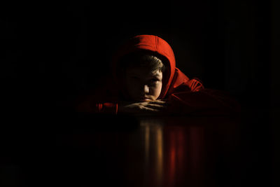 Portrait of boy in darkroom