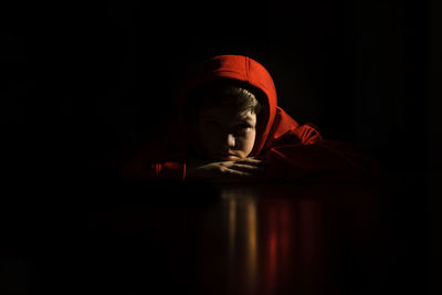 Teen boy on stomach with reflection on floor