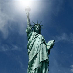 Low angle view of statue against blue sky