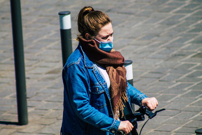 Full length of man standing on footpath in city