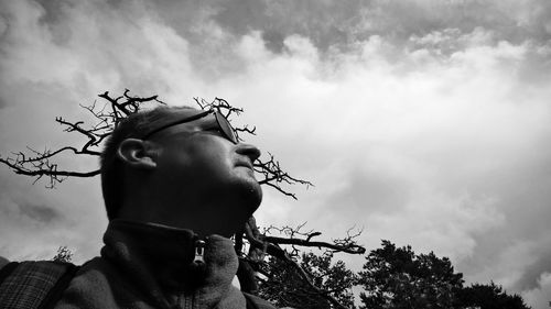 Low angle portrait of boy against sky