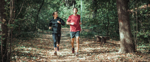 Full length of a man running in forest