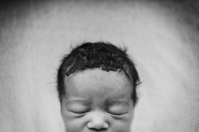 Close-up of baby sleeping on bed