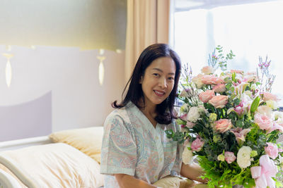 Portrait of young woman sitting at home