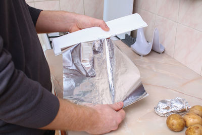 Midsection of man working on table