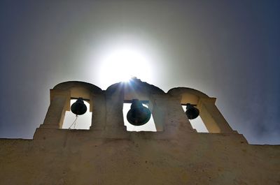 Low angle view of cross against sky on sunny day