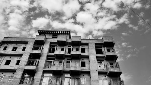 Low angle view of building against cloudy sky