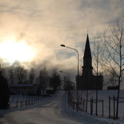 View of road against cloudy sky at sunset