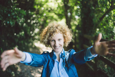 Portrait of smiling young woman in forest