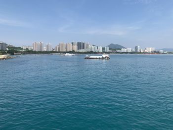 Scenic view of sea and buildings against sky