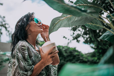 Side view of a man drinking glass