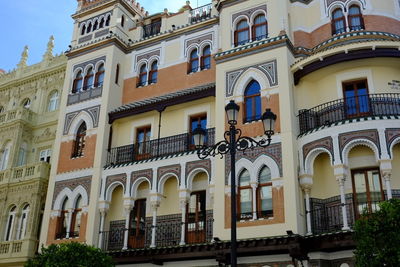 Low angle view of buildings in town against sky