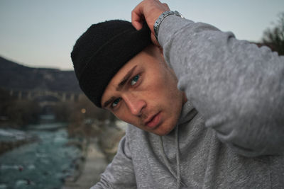 Portrait of young man wearing hat during winter