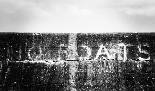 Text on water against sky