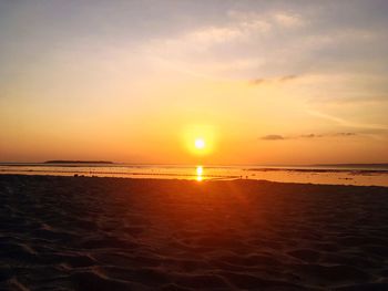 Scenic view of beach against sky during sunset